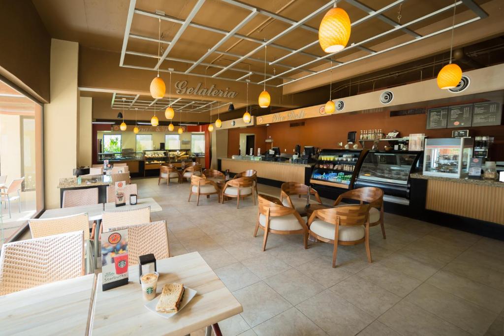 a restaurant with tables and chairs and a counter at Villa del Palmar Cancun Luxury Beach Resort & Spa in Cancún