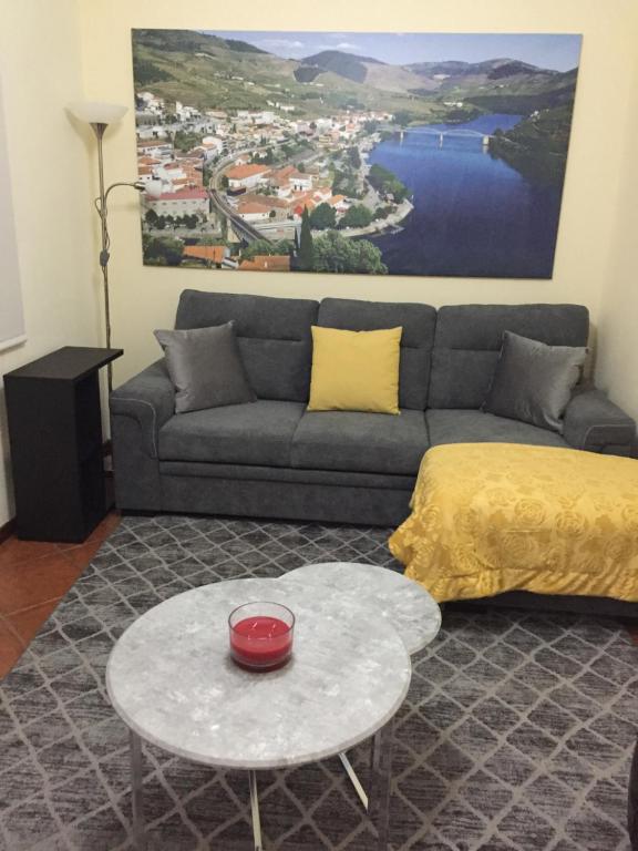 a living room with a couch and a table at Casa Seixas Batista in Pinhão