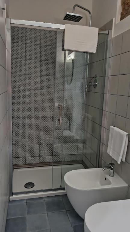 a bathroom with a shower and a toilet and a sink at “Sa Scala” Bed&Terrace in Baunei
