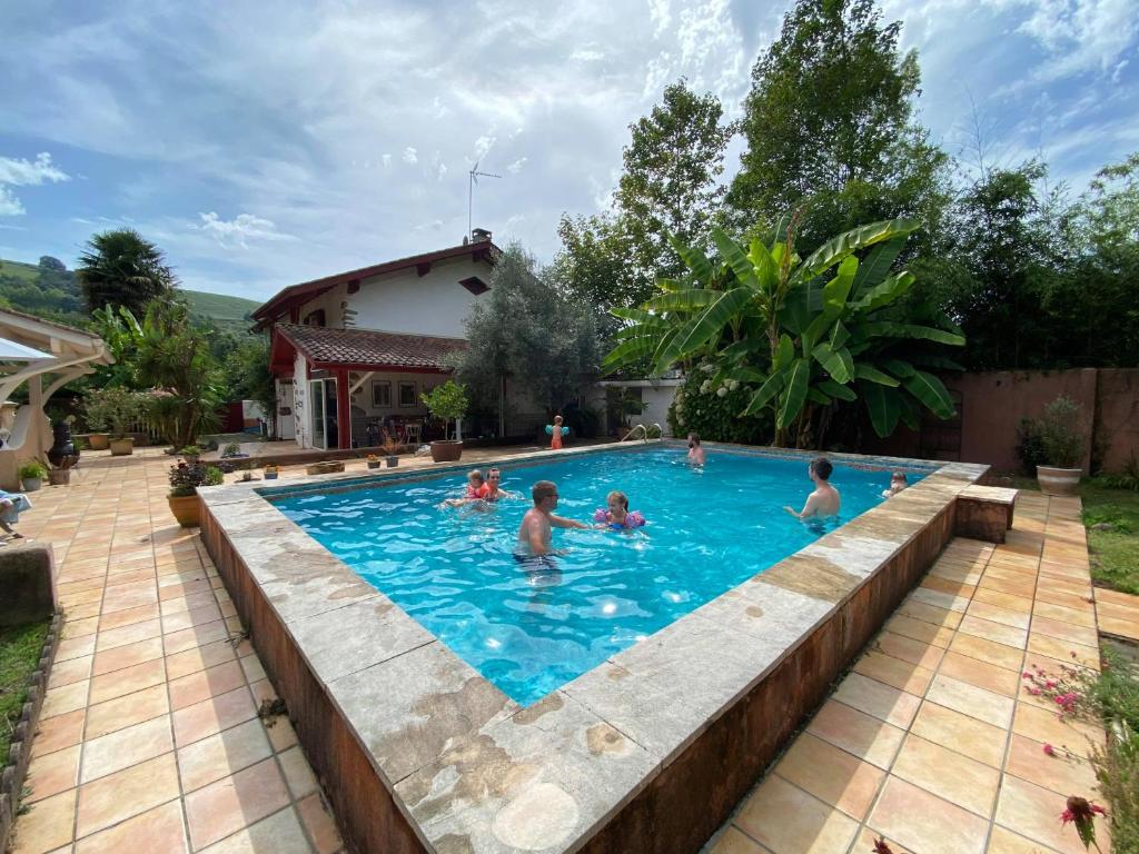a group of people in a swimming pool at Kapera Maison d'Hotes in Macaye