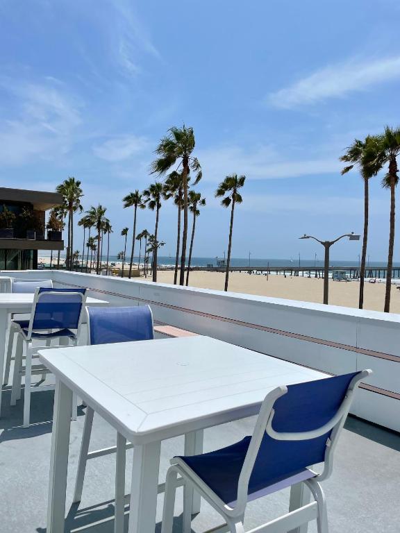 a white table and chairs on a balcony with the beach at Venice on the Beach Hotel in Los Angeles