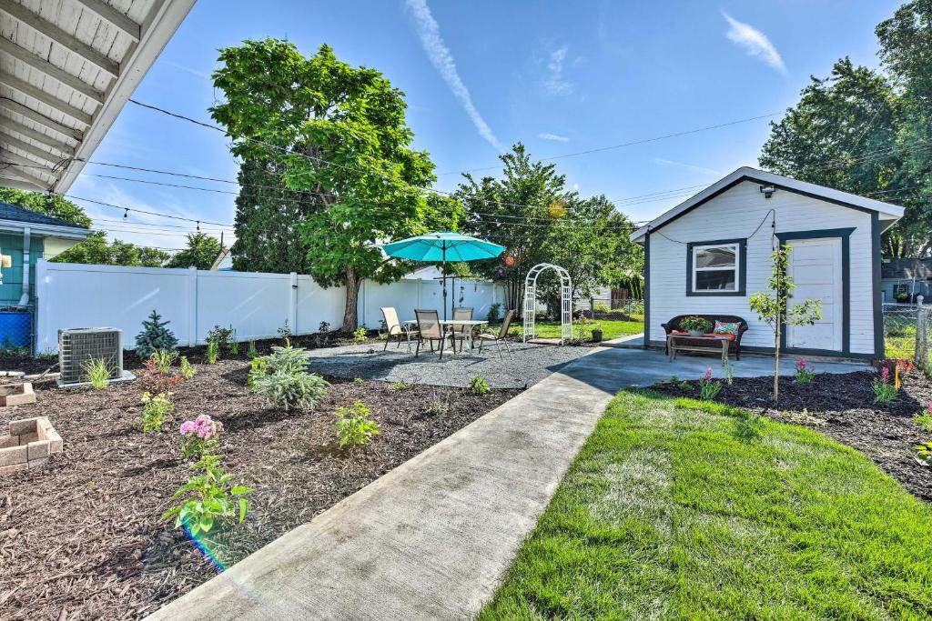 a backyard with a tiny house and a garden at Bright Mpls Getaway, 2 Mi to Minnehaha Falls! in Minneapolis