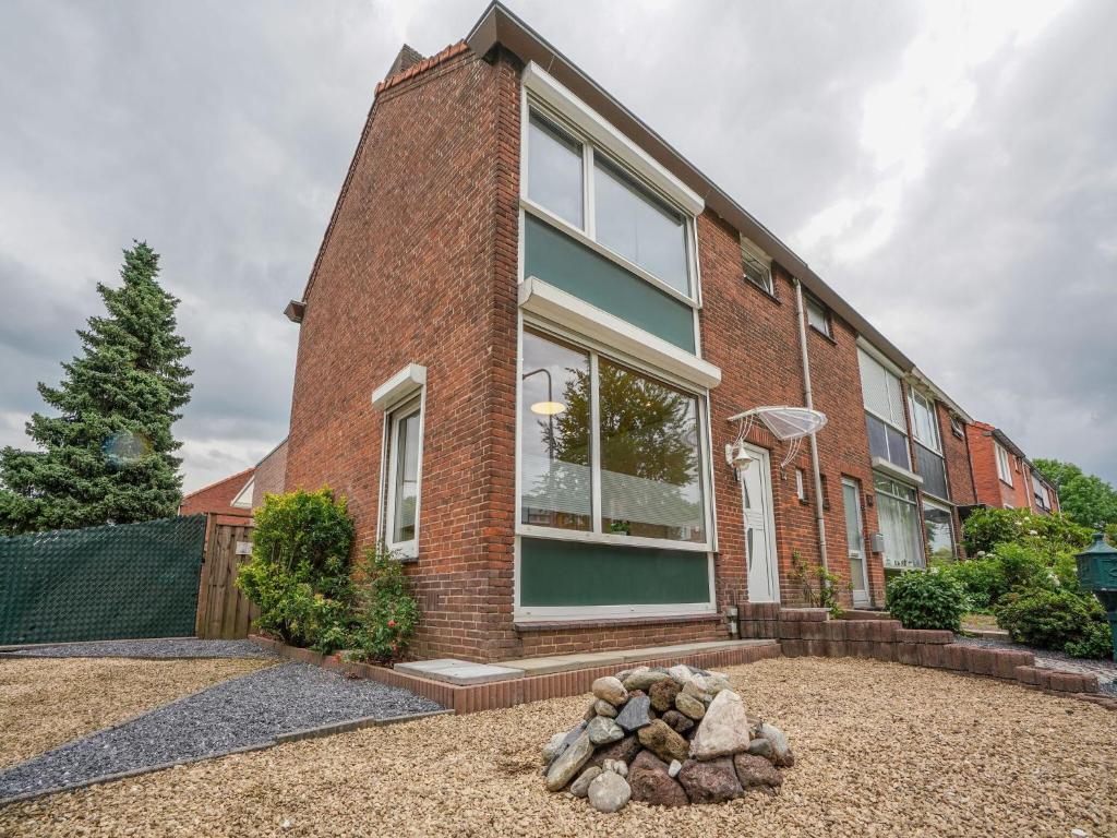 een stenen huis met een stapel stenen ervoor bij Terraced house in Kerkrade with a garden in Kerkrade