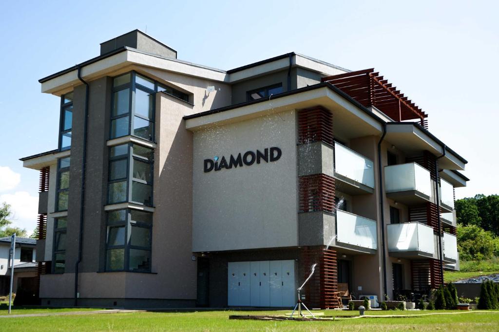 a building with the word damned on the side of it at Apartmany Arcadia in Podhájska