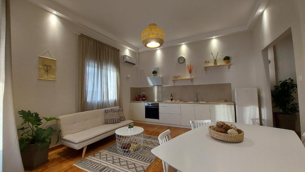 a living room with a couch and a table at Onar Beachfront Residence, Loutraki in Loutraki