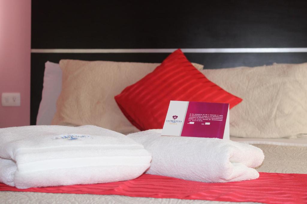 Postel nebo postele na pokoji v ubytování Hotel Boutique La Orquidea