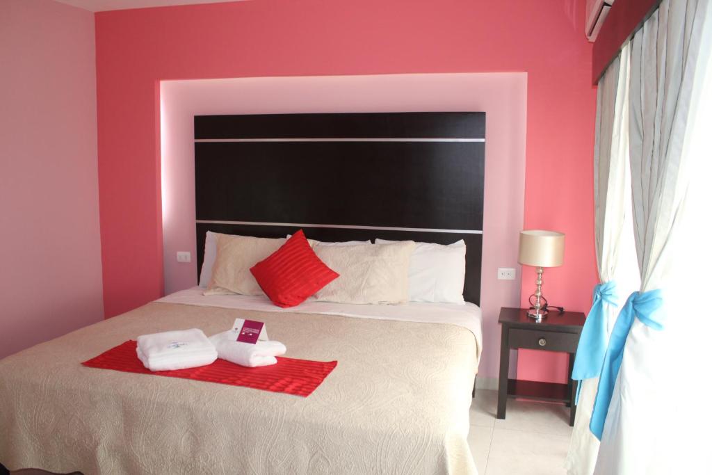 Postel nebo postele na pokoji v ubytování Hotel Boutique La Orquidea