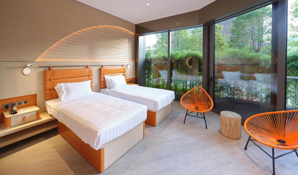 Ένα ή περισσότερα κρεβάτια σε δωμάτιο στο WM Hotel Hong Kong, Vignette Collection
