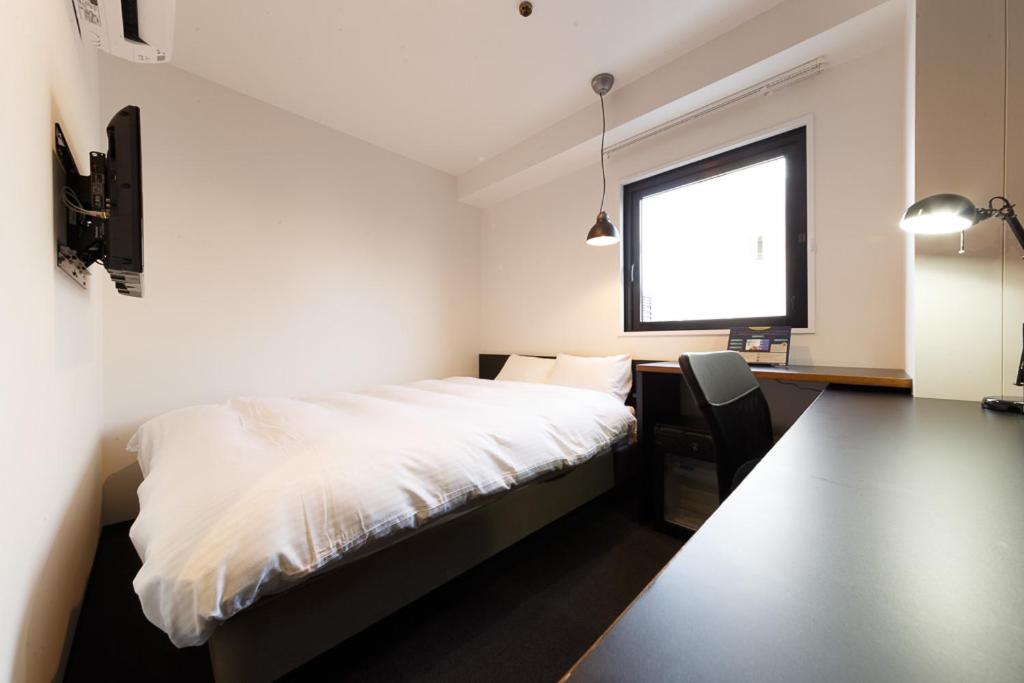 Postel nebo postele na pokoji v ubytování Hotel Citio Shizuoka