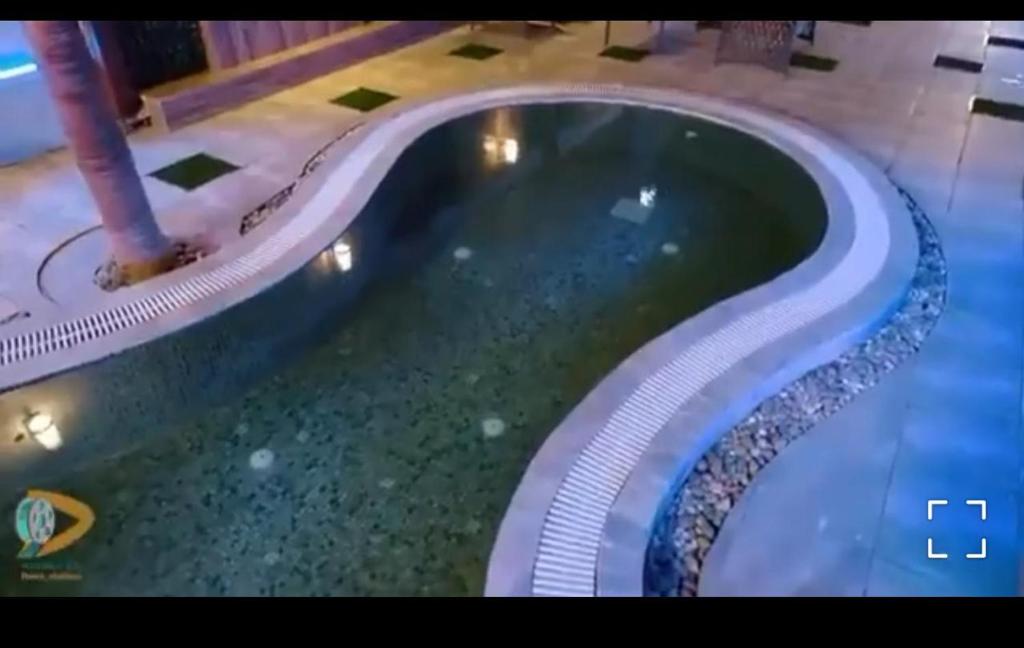 a swimming pool in a building with a swimming pool at شاليه اوتار Strings Chalet in Riyadh