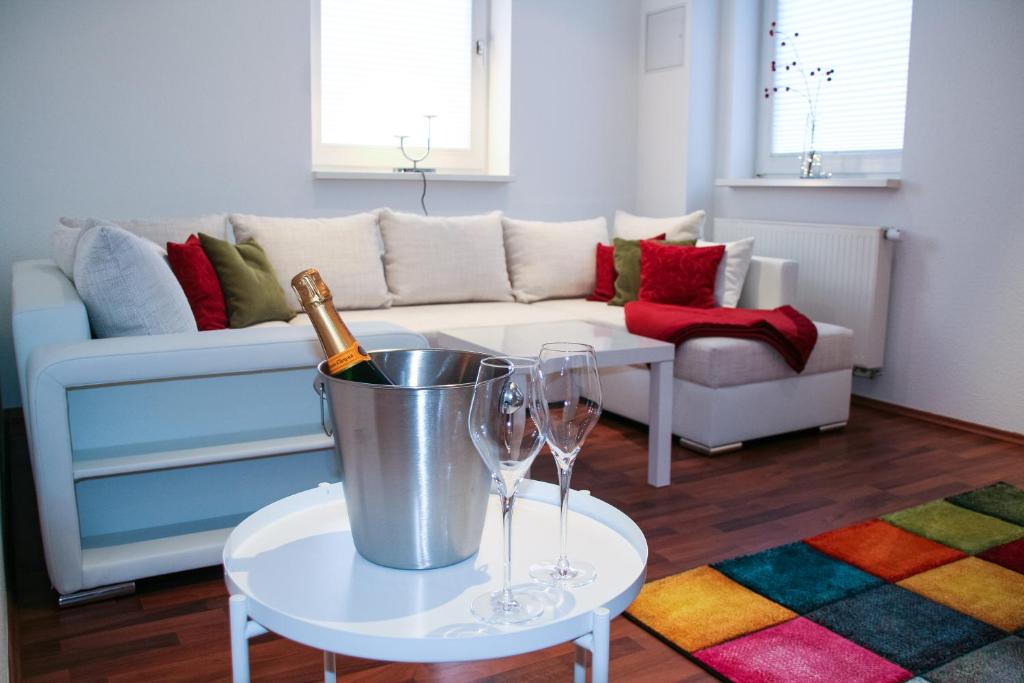 eine Weinflasche in einem Eimer auf einem Tisch im Wohnzimmer in der Unterkunft Premium Ferienwohnung Südsonne in Witzenhausen