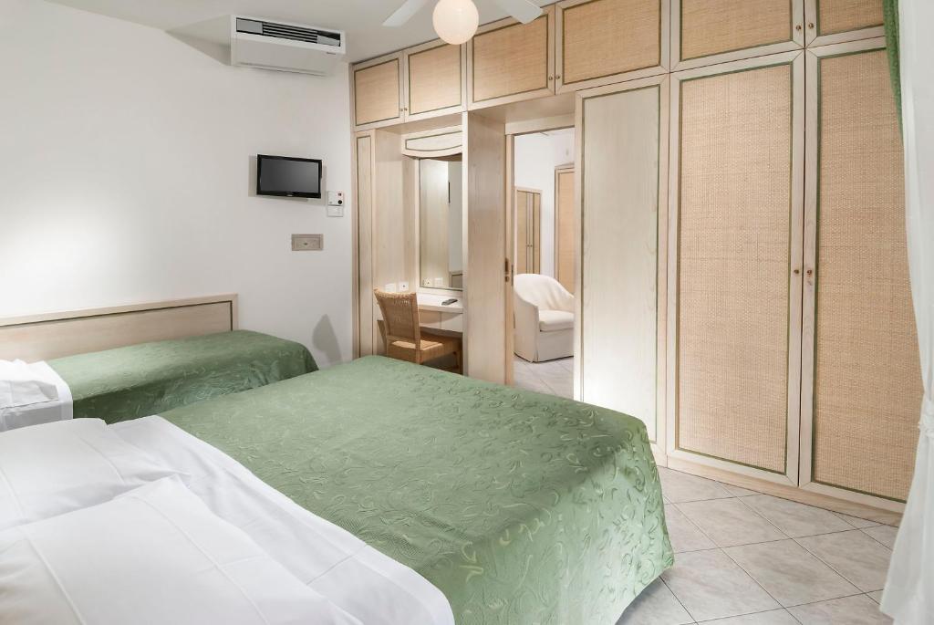 Postel nebo postele na pokoji v ubytování Hotel Lido