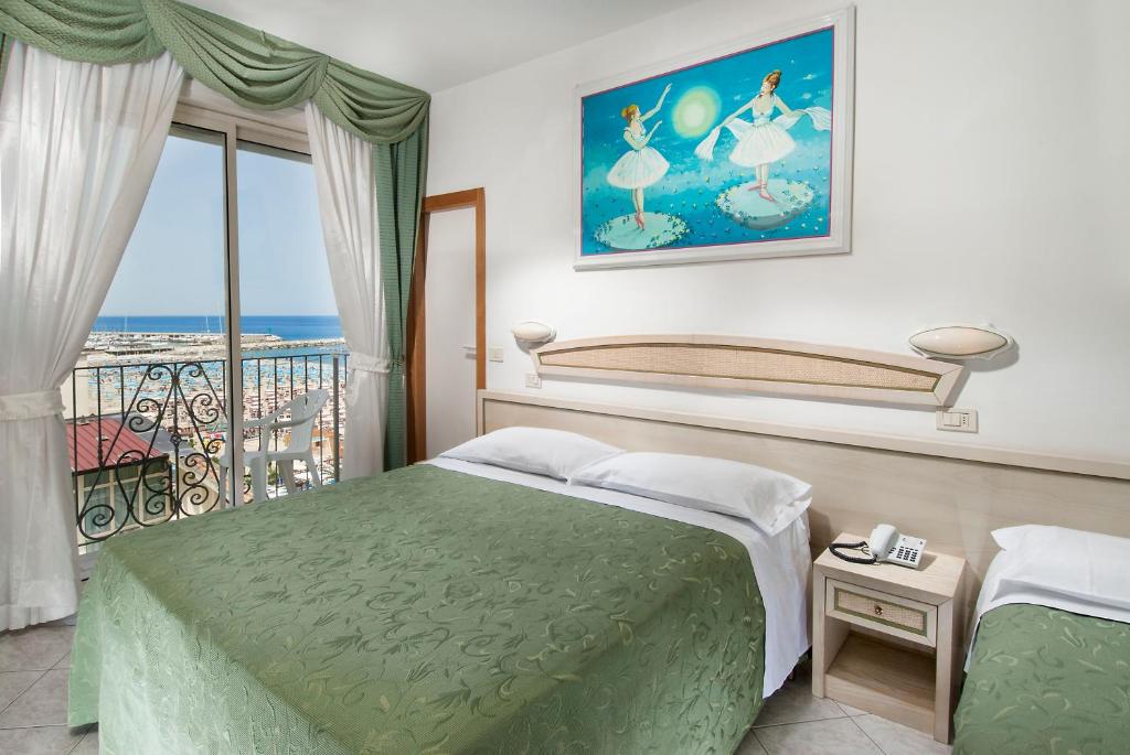 Postel nebo postele na pokoji v ubytování Hotel Lido