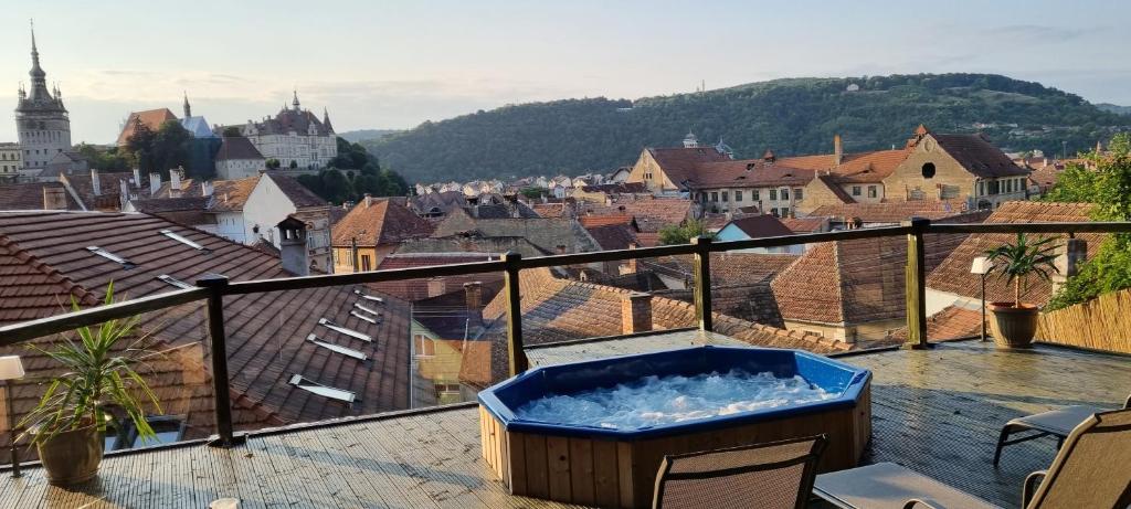 a hot tub on a balcony overlooking a city at Am Goldberg in Sighişoara