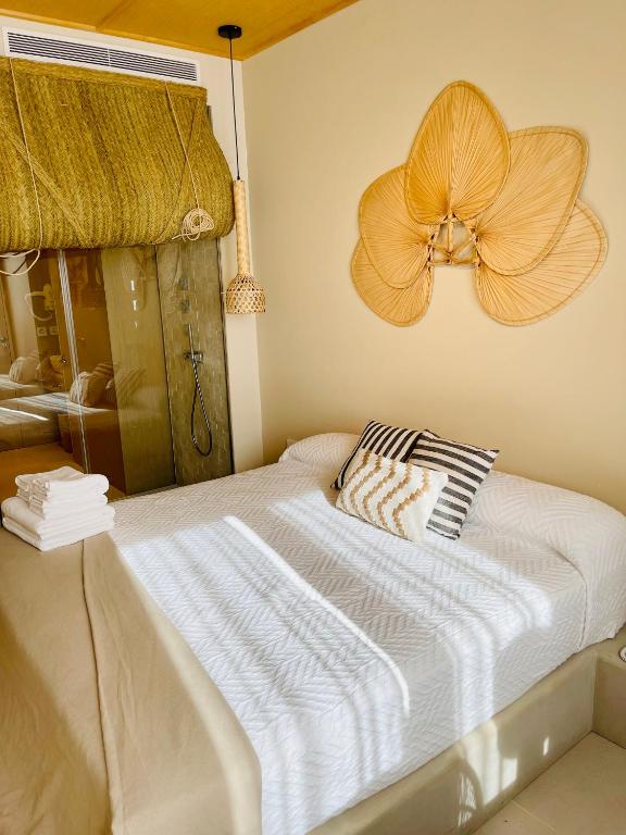 a bedroom with a bed with a flower on the wall at Hotel Boutique Sabbia Valencia in Valencia