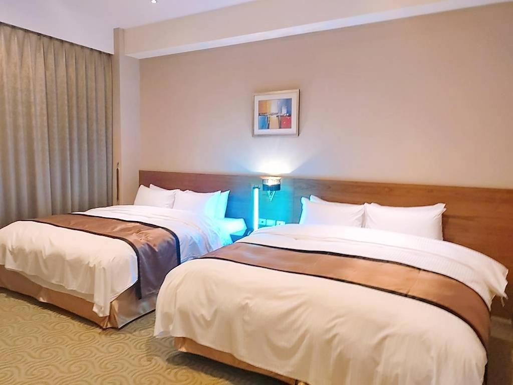 Postel nebo postele na pokoji v ubytování Jade Garden Hote
