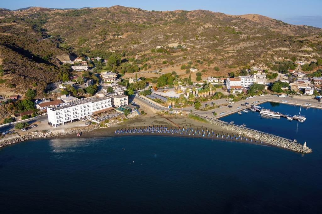 an aerial view of a town and a harbor at Tylos Beach Hotel in Kato Pyrgos