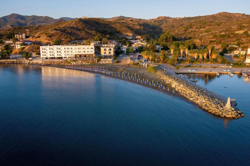 an aerial view of a beach with buildings and the water at Tylos Beach Hotel in Kato Pyrgos