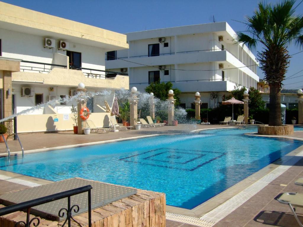a swimming pool in front of a building at Antonios Hotel in Faliraki