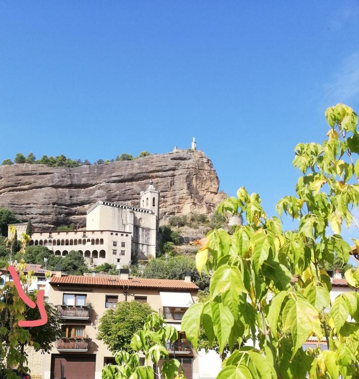 a castle on top of a mountain with trees at Casas Natura - Centro Graus in Graus