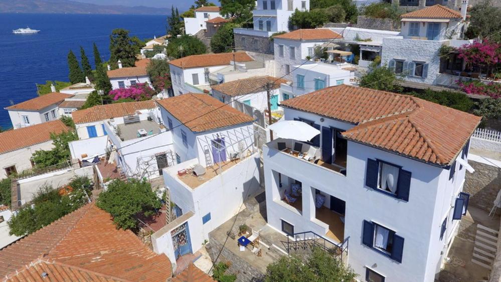 an aerial view of a town with houses and the ocean at Options House in Hydra