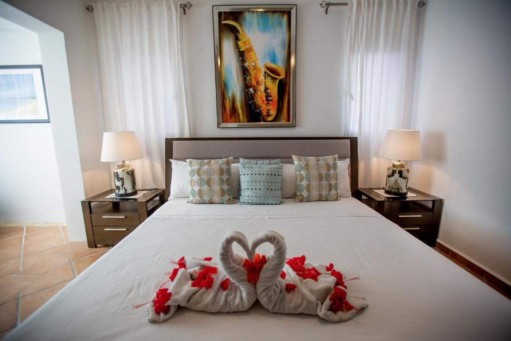 a bedroom with two swans made to look like hearts at Rolando share apart in Punta Cana