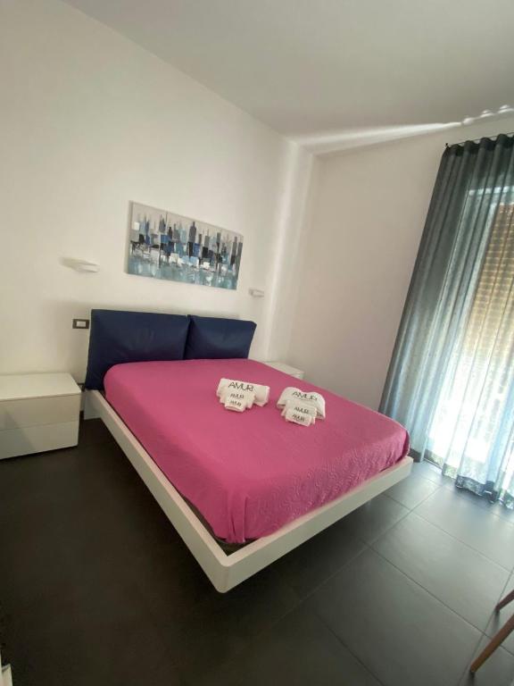 Postel nebo postele na pokoji v ubytování Amuri Room&Suite