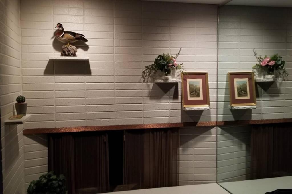 a wall with a shelf with pictures on it at Charming Home In Quiet Grangeville Neighborhood in Grangeville