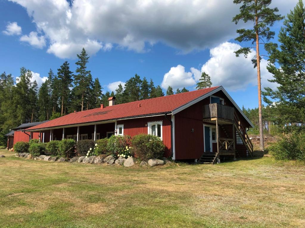 a red house with a red roof at Modal Annex in Hultsfred