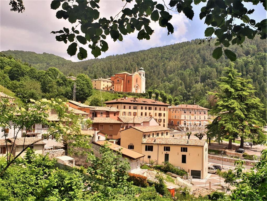 a town on a hill with trees and buildings at Hotel Baldo in Ferraro di Monte Baldo