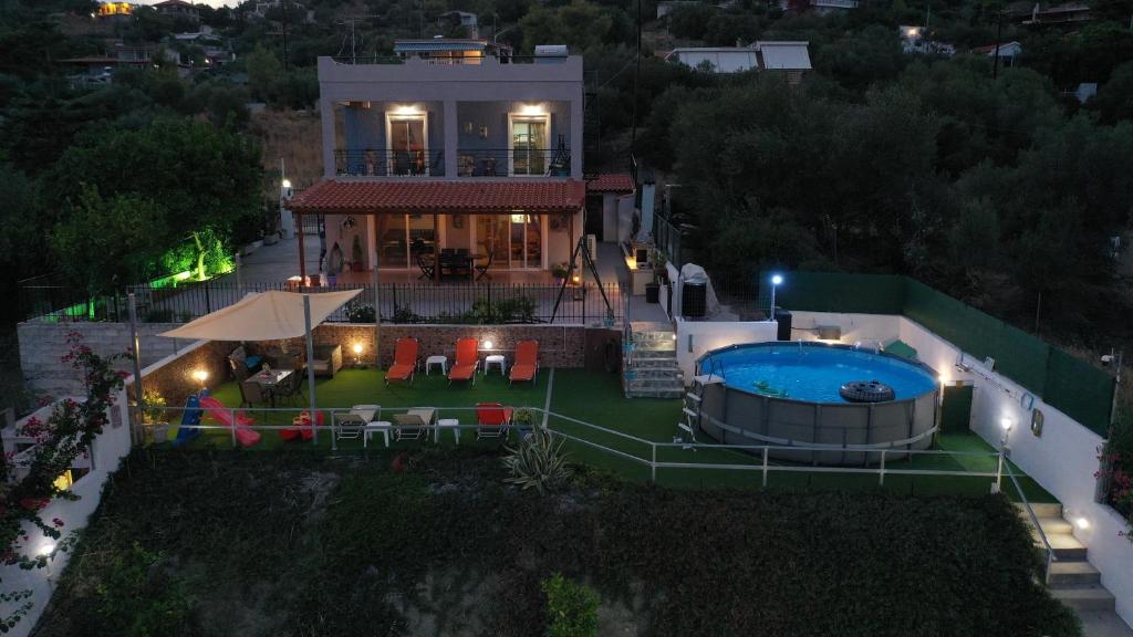 an aerial view of a house with a swimming pool at Thalassa in Panayía