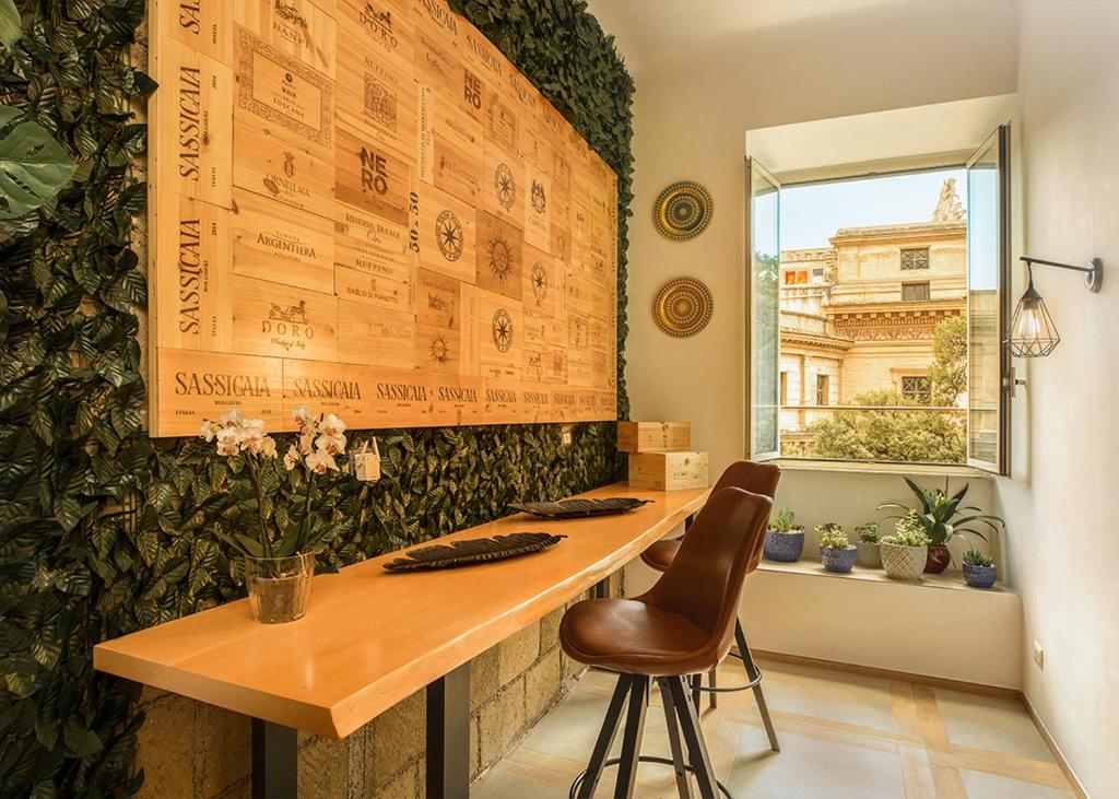 a room with a table and a chair and a window at Salus Inn in Rome