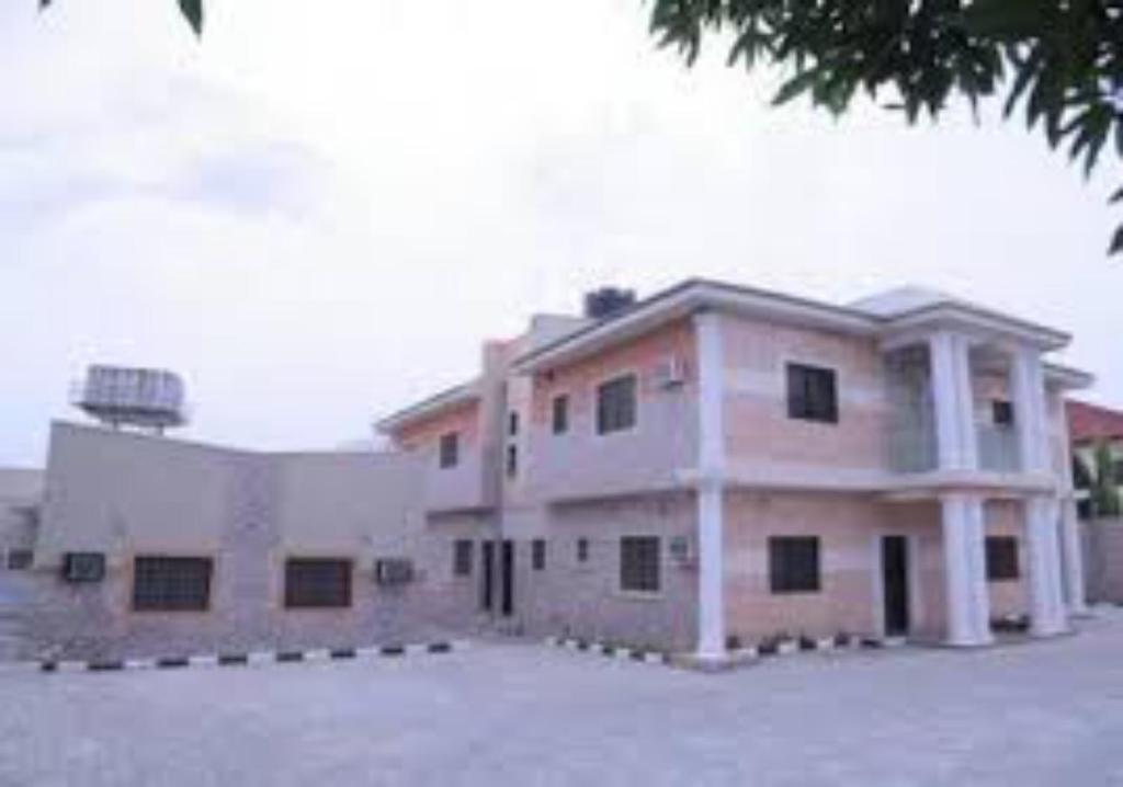 a large building with a lot of windows in a parking lot at Dilida Guest Suites-standard in Jabi