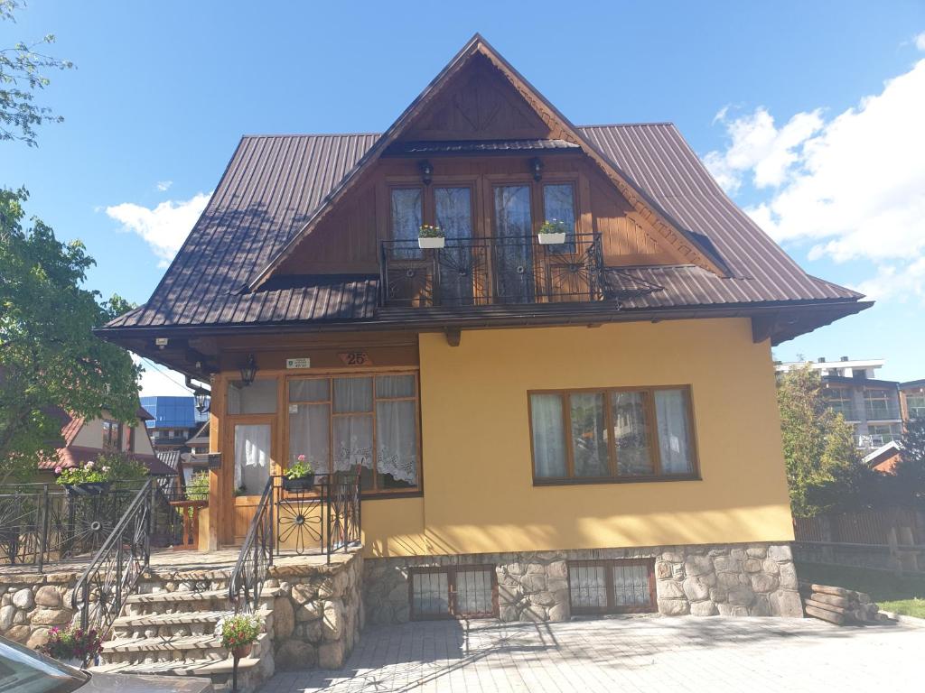 a house with a brown roof and windows at Rezydencja Nosal in Zakopane
