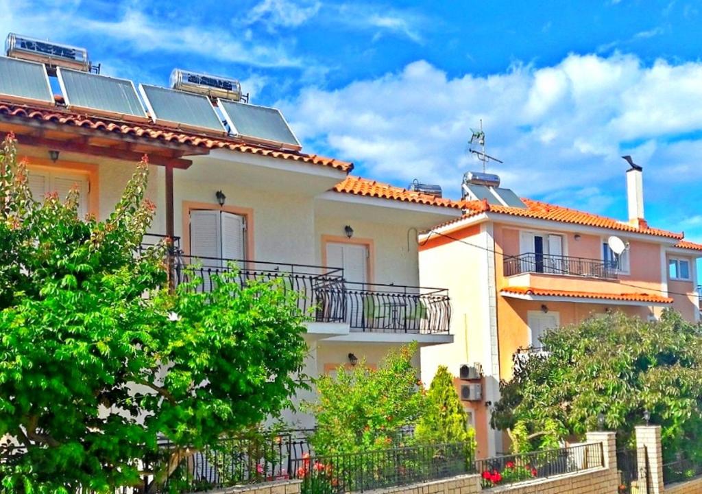 a house with solar panels on the roof at Dionysios Studios in Skala