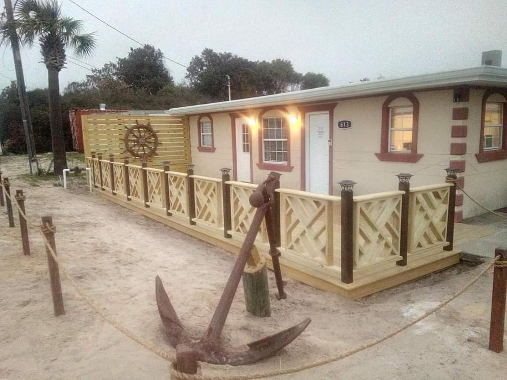 a house with a large anchor in front of it at Motel Safreen in Panama City Beach