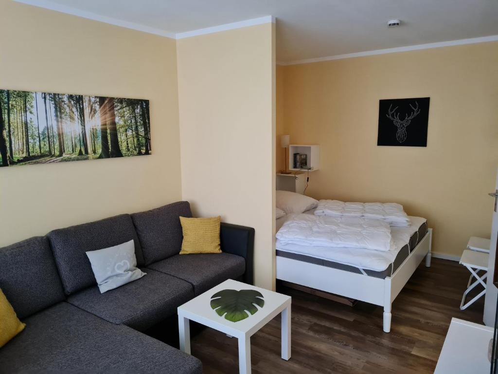 a living room with a couch and a bed at Bergstation Altenau in Altenau