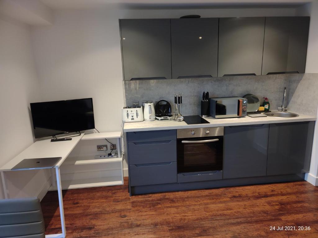 a kitchen with blue cabinets and a counter top at Earl Street124 in Sheffield