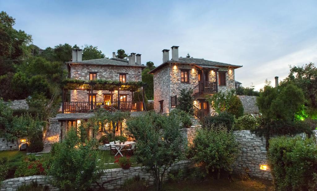 an exterior view of a large stone house at Adis Oneirou in Mouresi