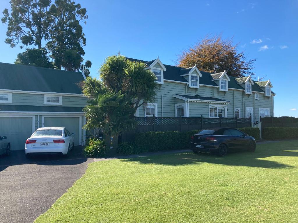 a white car parked in front of a house at Taiparoro House in Tauranga