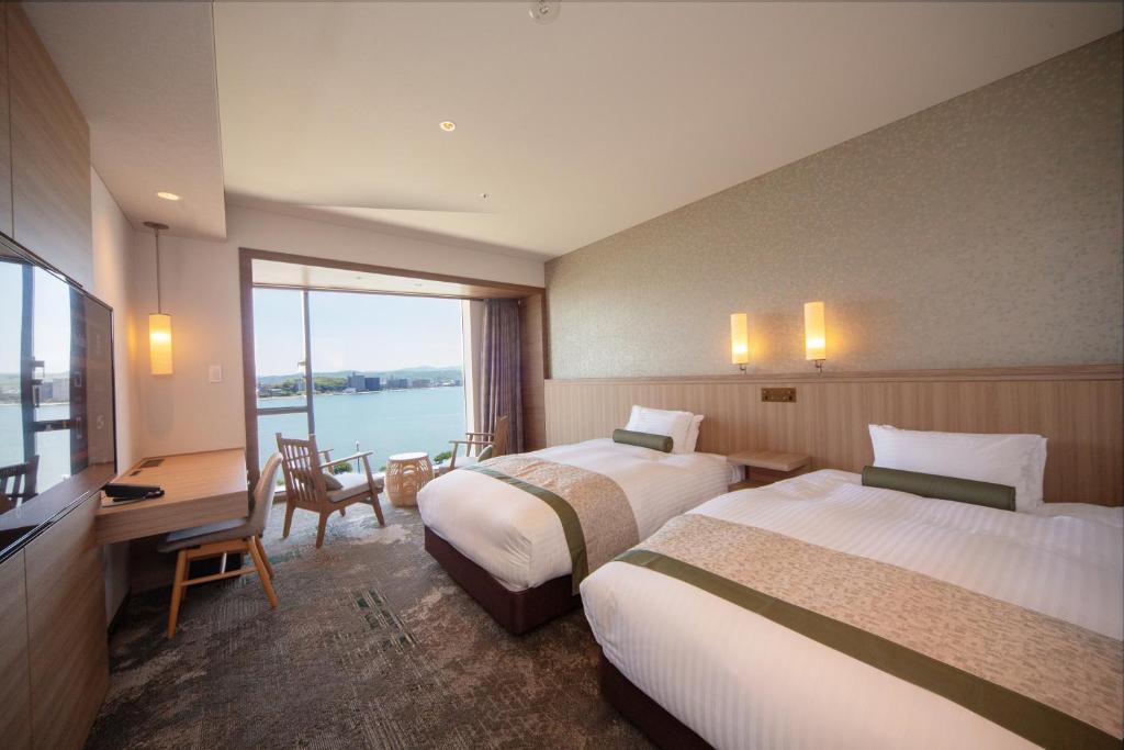 Postel nebo postele na pokoji v ubytování Hotel Ichibata