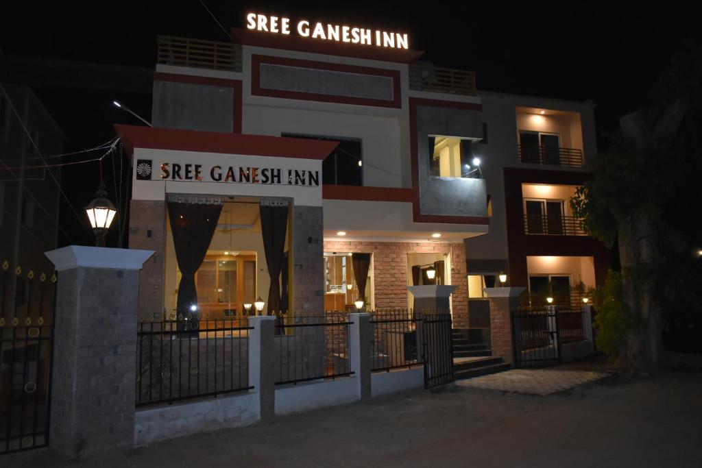 a building with a sign that reads she gaussian inn at Sree Ganesh Inn in Palni