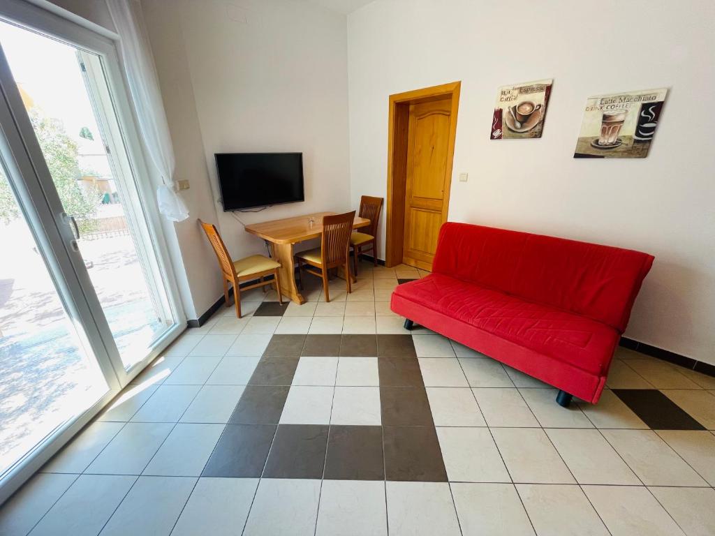 Televízia a/alebo spoločenská miestnosť v ubytovaní Apartments Basilea