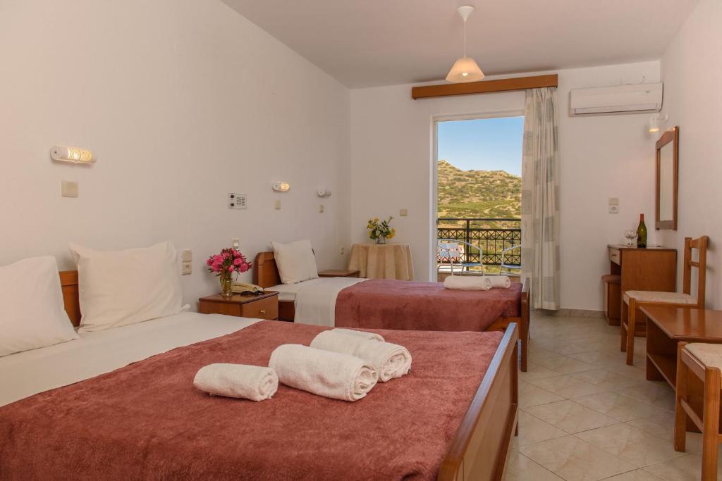 Postel nebo postele na pokoji v ubytování Melissa Hotel