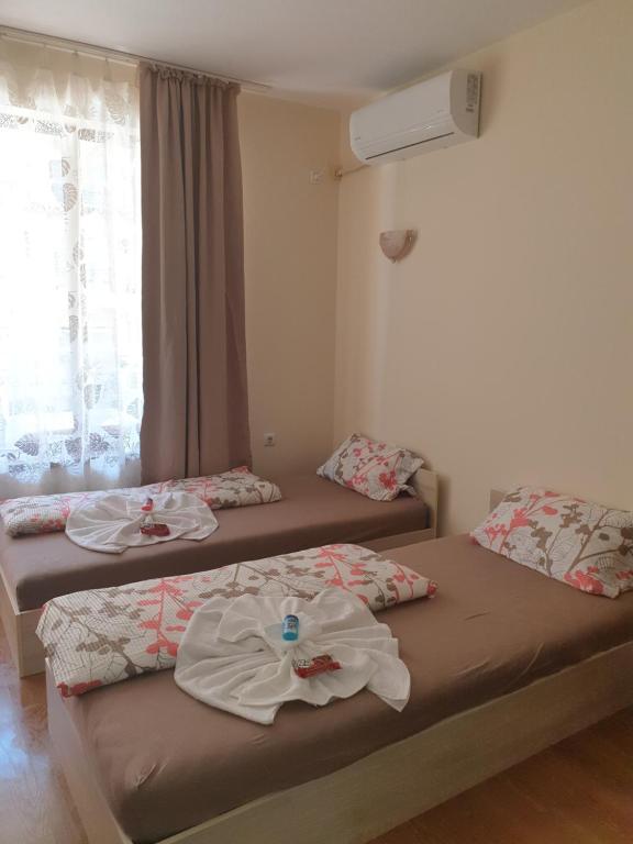 two beds sitting in a room with a window at Hotel Royal Dreams Beach only 5min in Sunny Beach