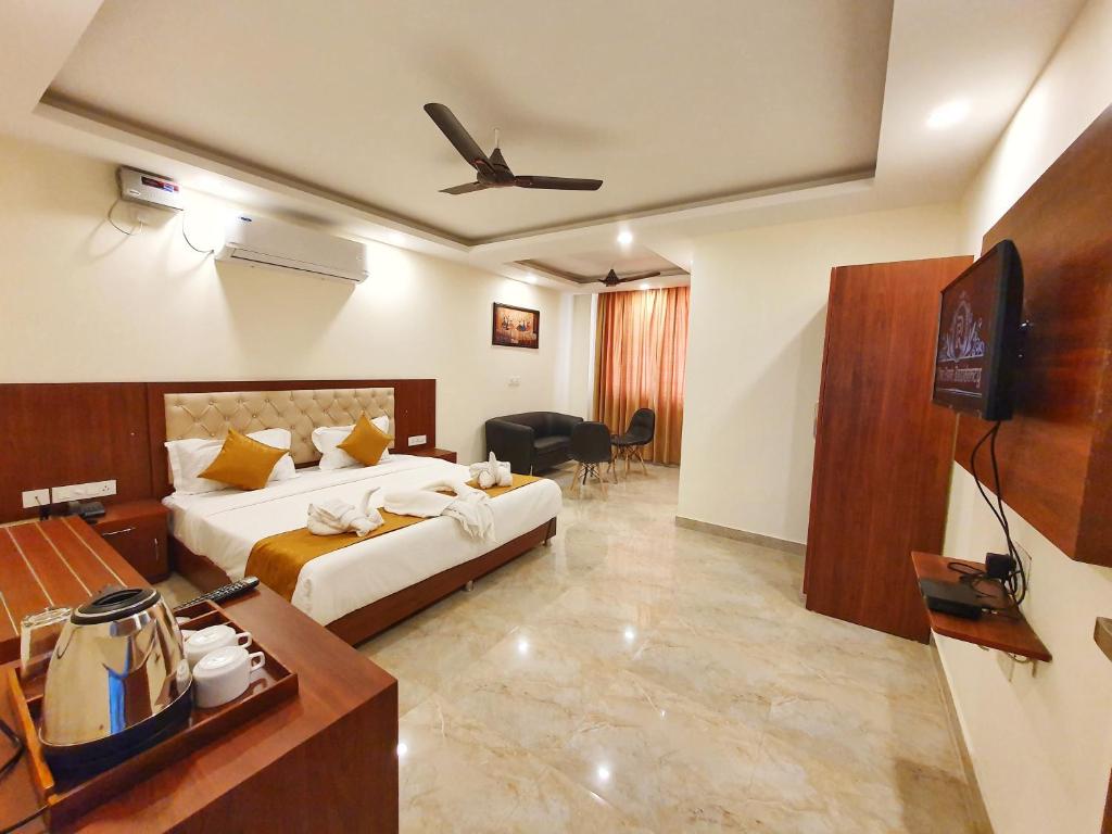 a hotel room with a bed and a flat screen tv at The Park Residency in Dehradun