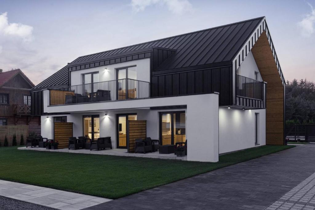 a rendering of a house with a black roof at LILIOWA 15 in Dębki