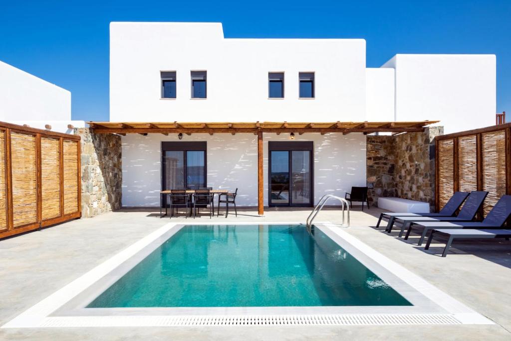 a villa with a swimming pool and a house at Cato Agro 2, Seafront Villa with Private Pool in Karpathos Town