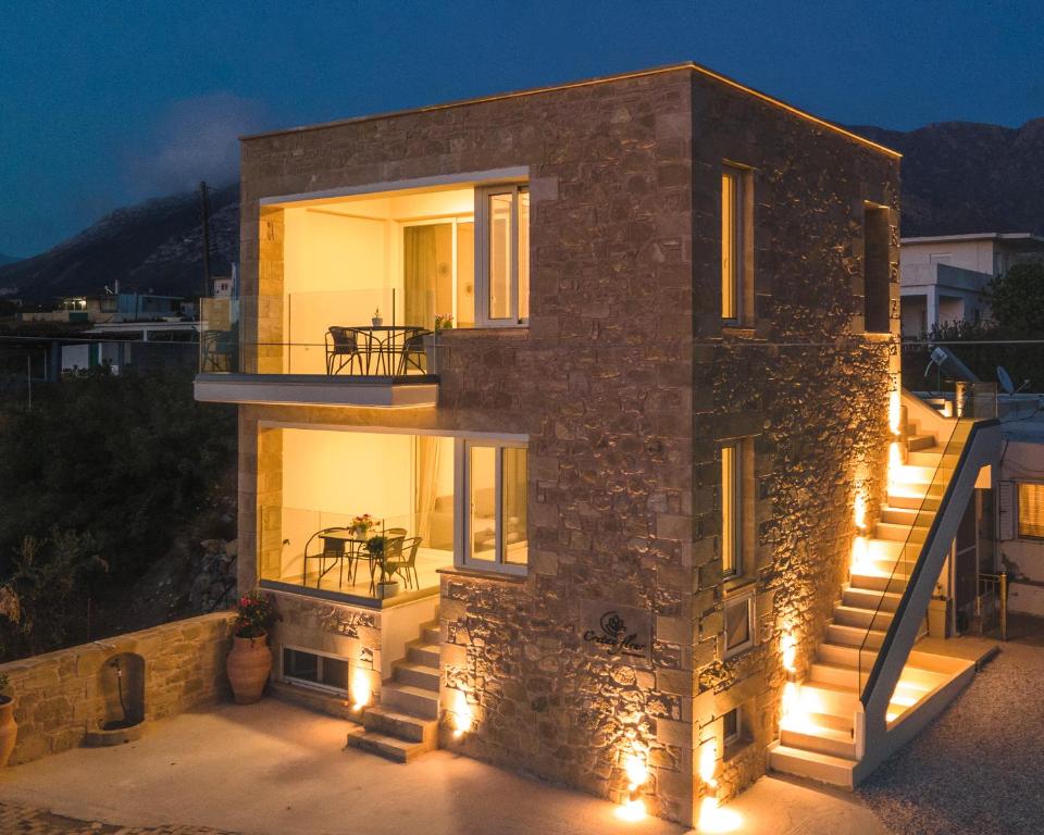 a stone house with lights on it at night at Cretan fleur apartments in Elafonisi