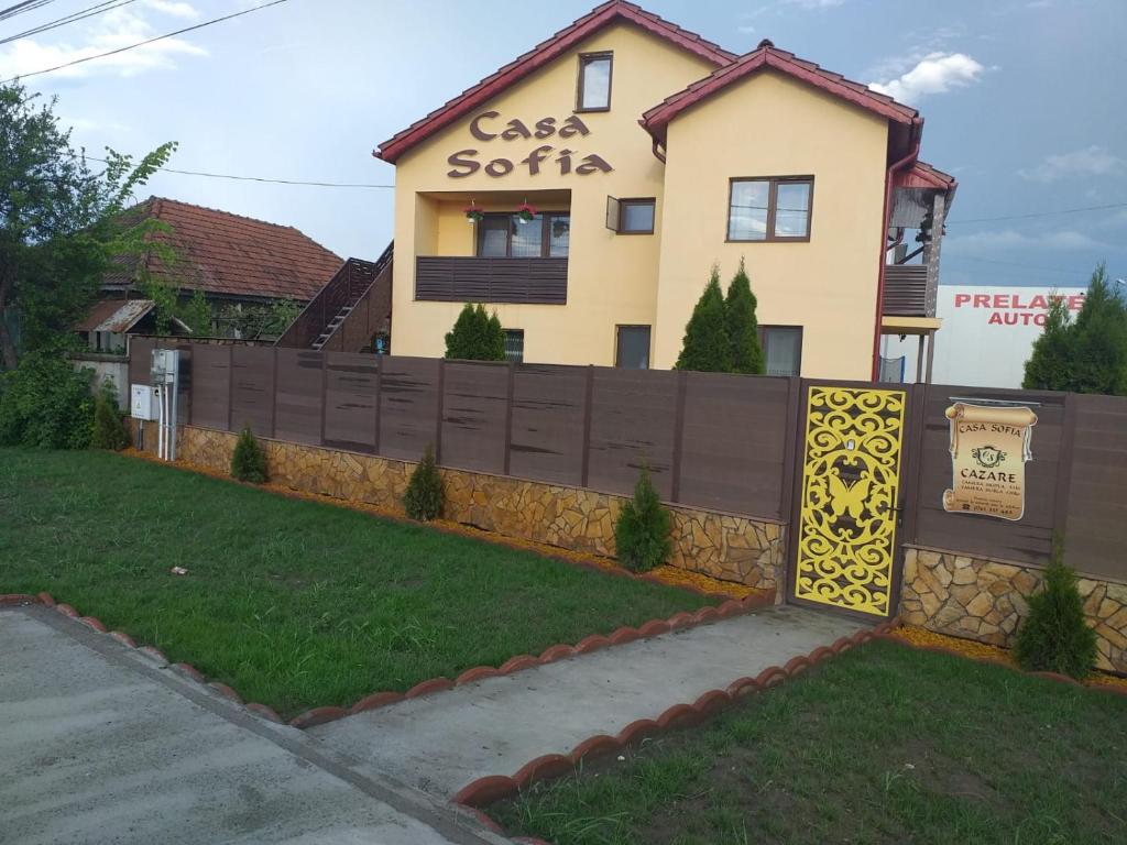 una casa con una valla delante de ella en Casa Sofia, en Târgu Jiu